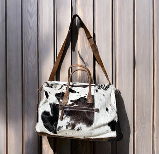 All cowhide rolling duffle bag