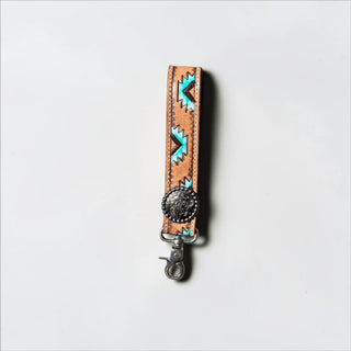 Aztec tooled leather wristlet