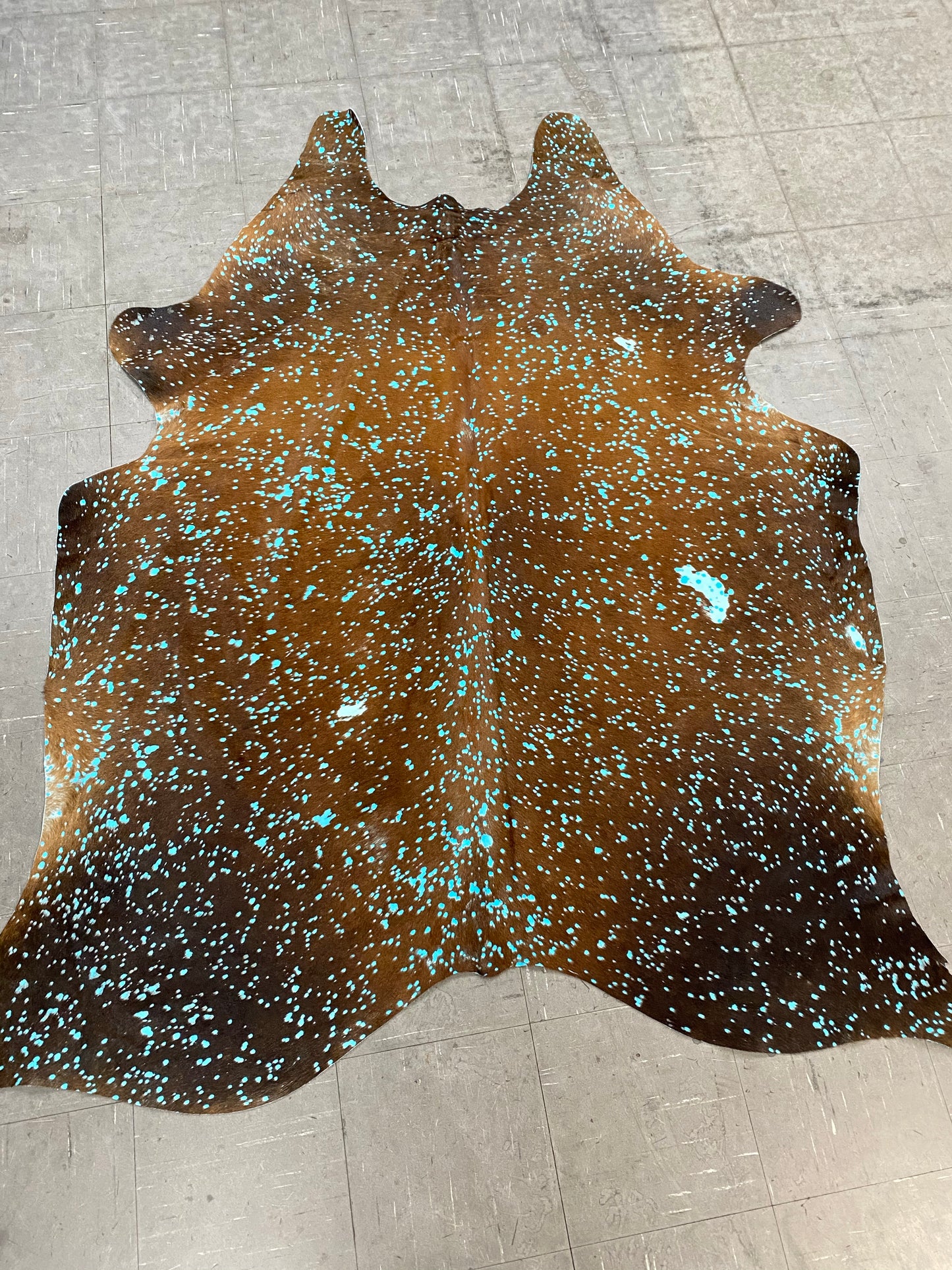 Dyed turquoise on brown cowhide